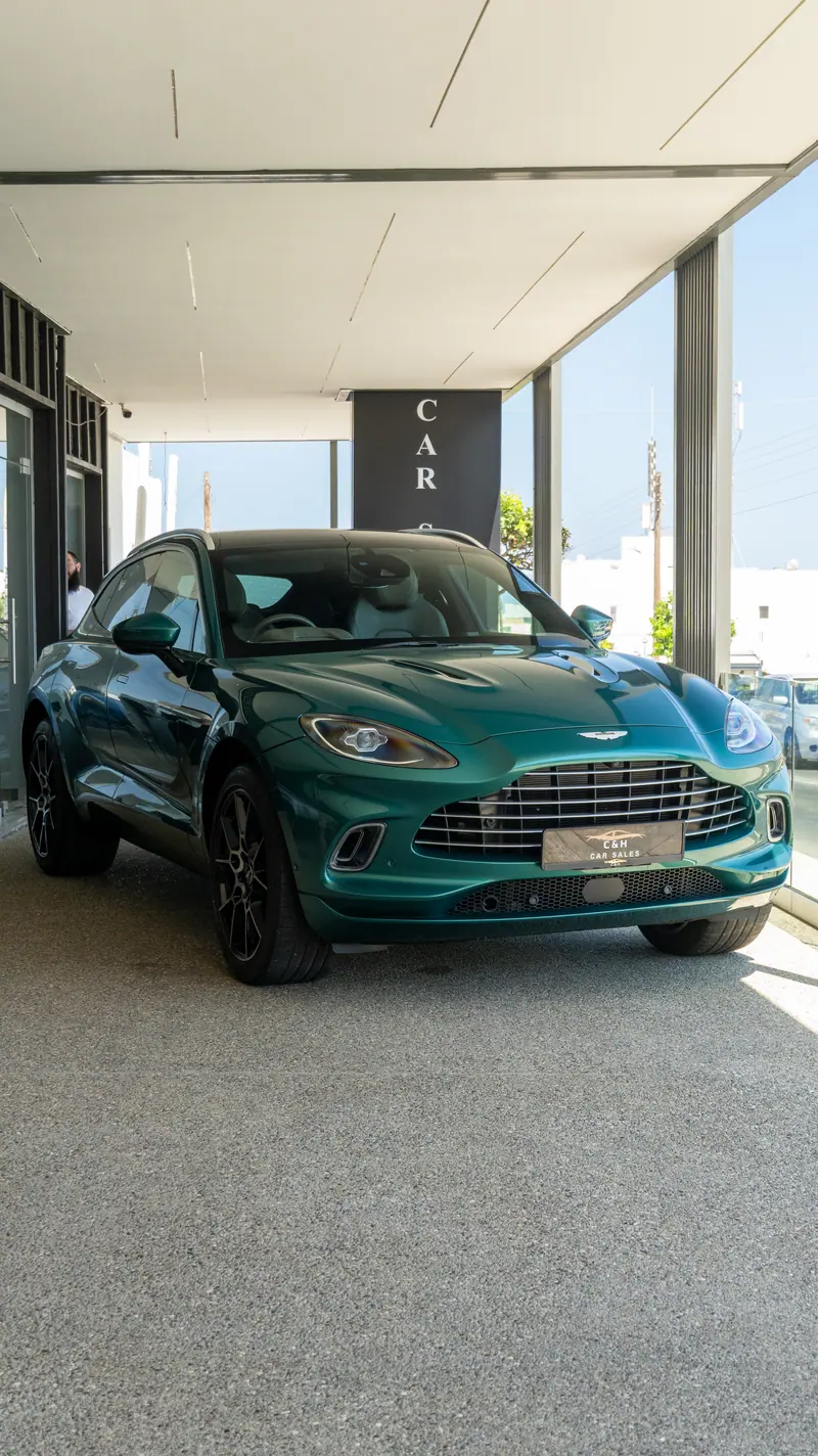 Green Aston Martin SUV on the C&H Car Sales forecourt