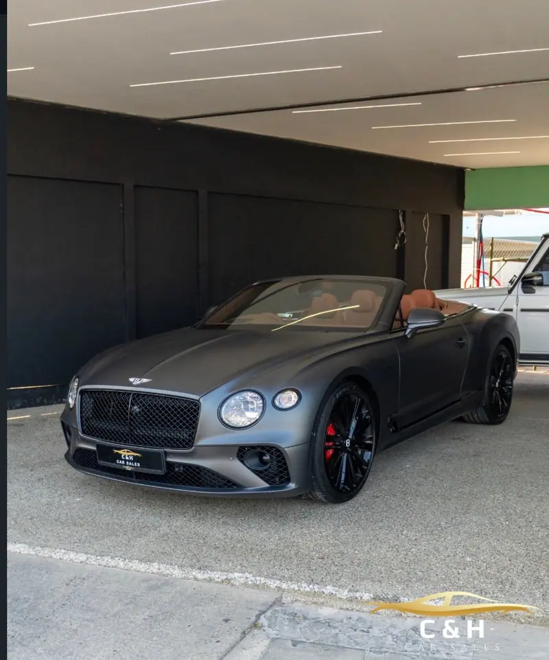 Grey Bentley convertible in the C&H Car Sales showroom