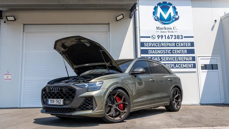 Audi SUV with its bonnet up outside the Marcou C. Autotech workshop