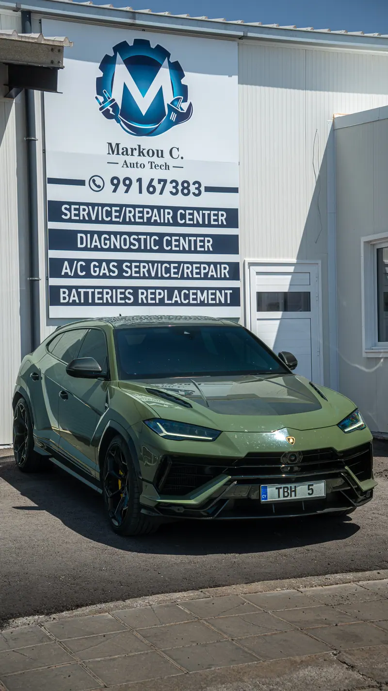 Green Lamborghini Urus in front of the Marcou C. Autotech sign