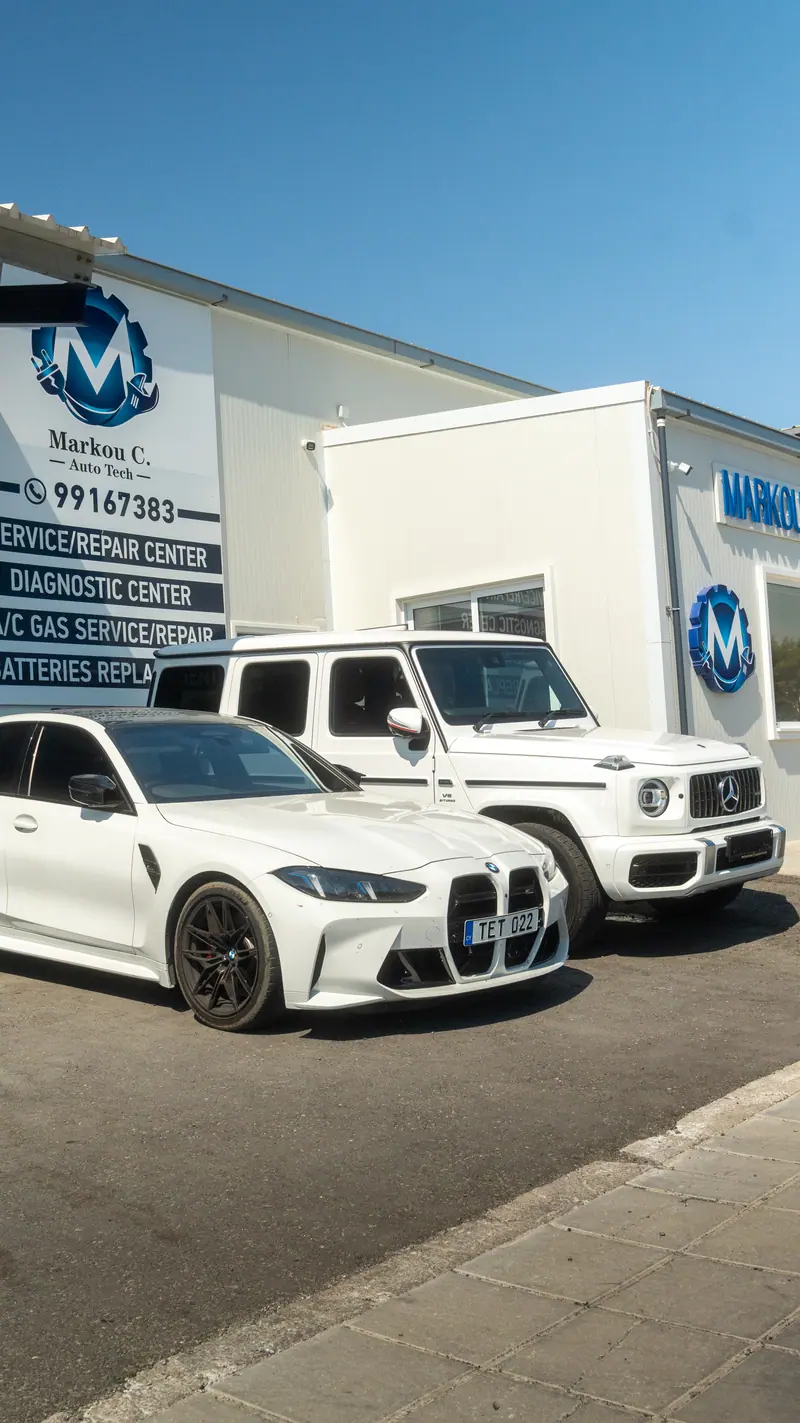White BMW and white G-Class outside the Marcou C. Autotech workshop